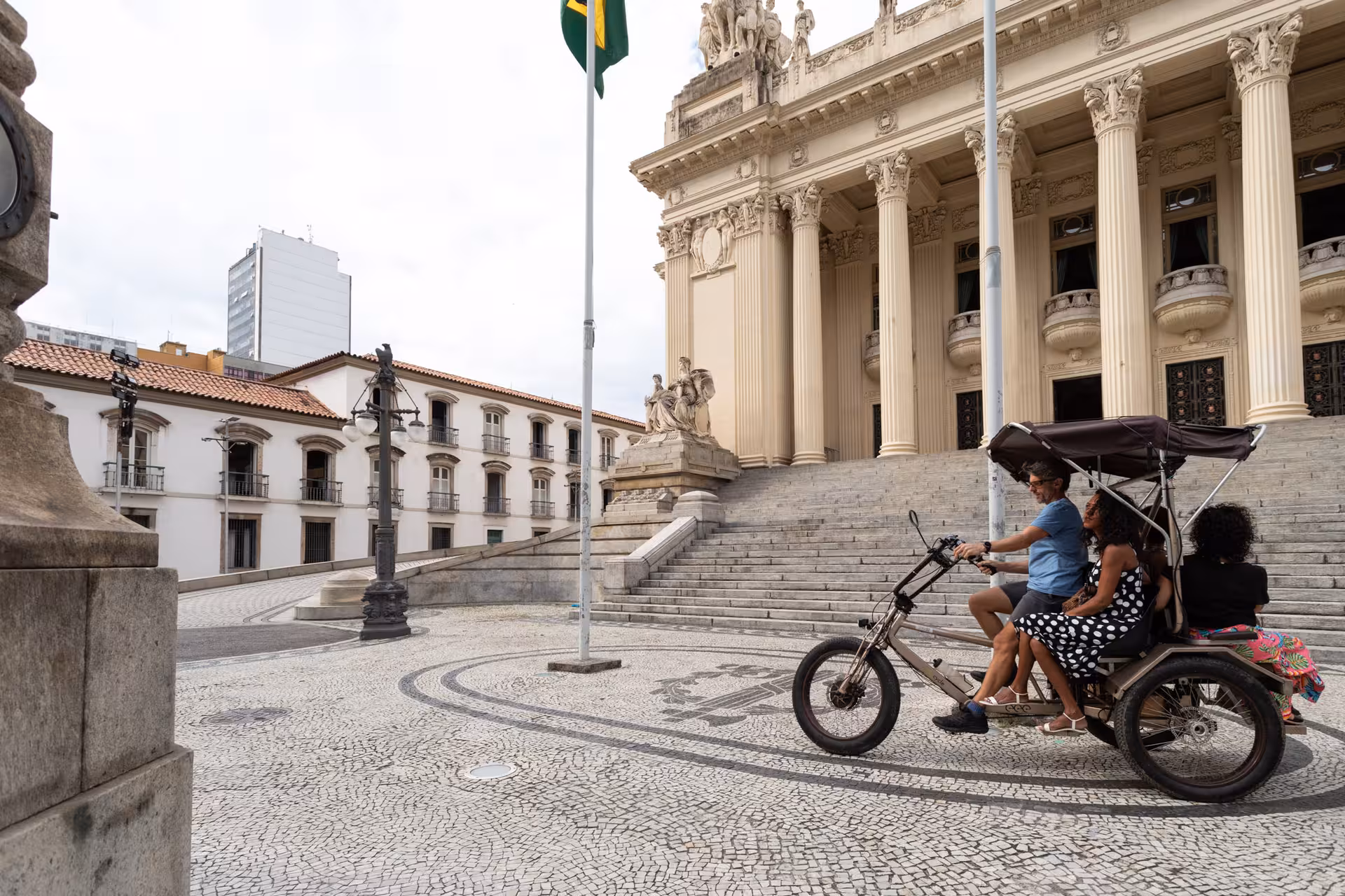 Pedicab tour in Rio de Janeiro historical city centre, riding past the grand Theatro Municipal and plaza