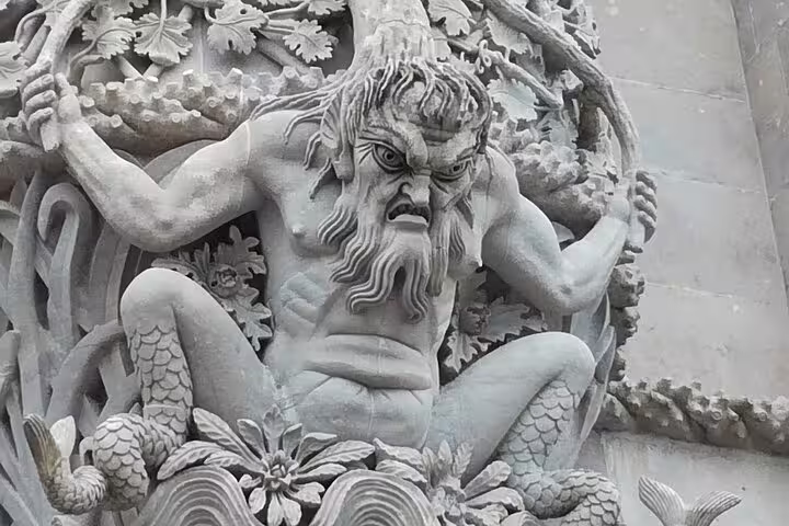 Detailed sculpture of a mythological figure at Pena Palace, highlighting the artistic craftsmanship in Sintra's iconic site.