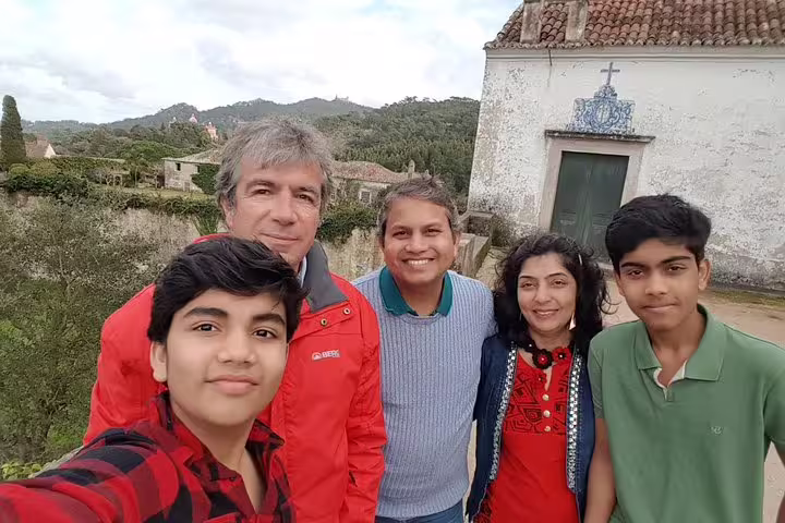 Group enjoying scenic views at Pena Palace during Sintra, Roca, and Cascais full-day private tour with tickets included.