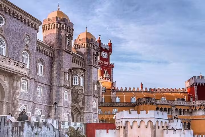 Colorful, ornate facade of Pena Palace in Sintra, Portugal, showcasing romantic architecture on a half-day guided tour.