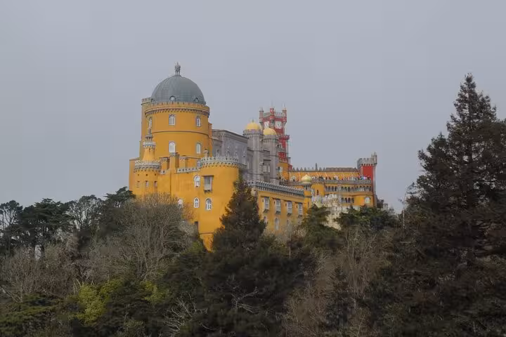 Marvel at the stunning architecture of Pena Palace from Sintra's highest point on an exclusive day tour.