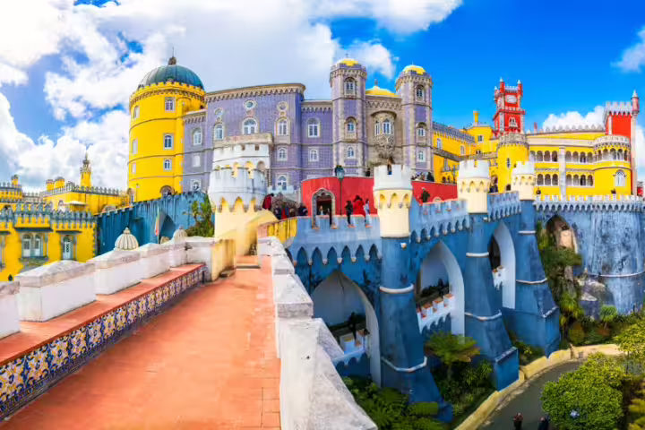 Colorful view of Pena Palace in Sintra with vibrant architecture, perfect for Lisbon tour exploring Roca Cape Coast and Cascais.