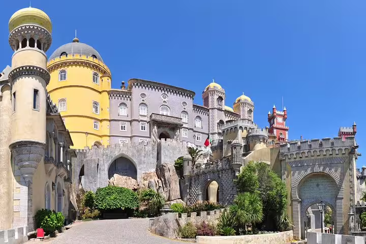Pena Palace in Sintra, Portugal, featuring vibrant architecture, lush gardens, and stunning views, part of a full-day Lisbon tour.