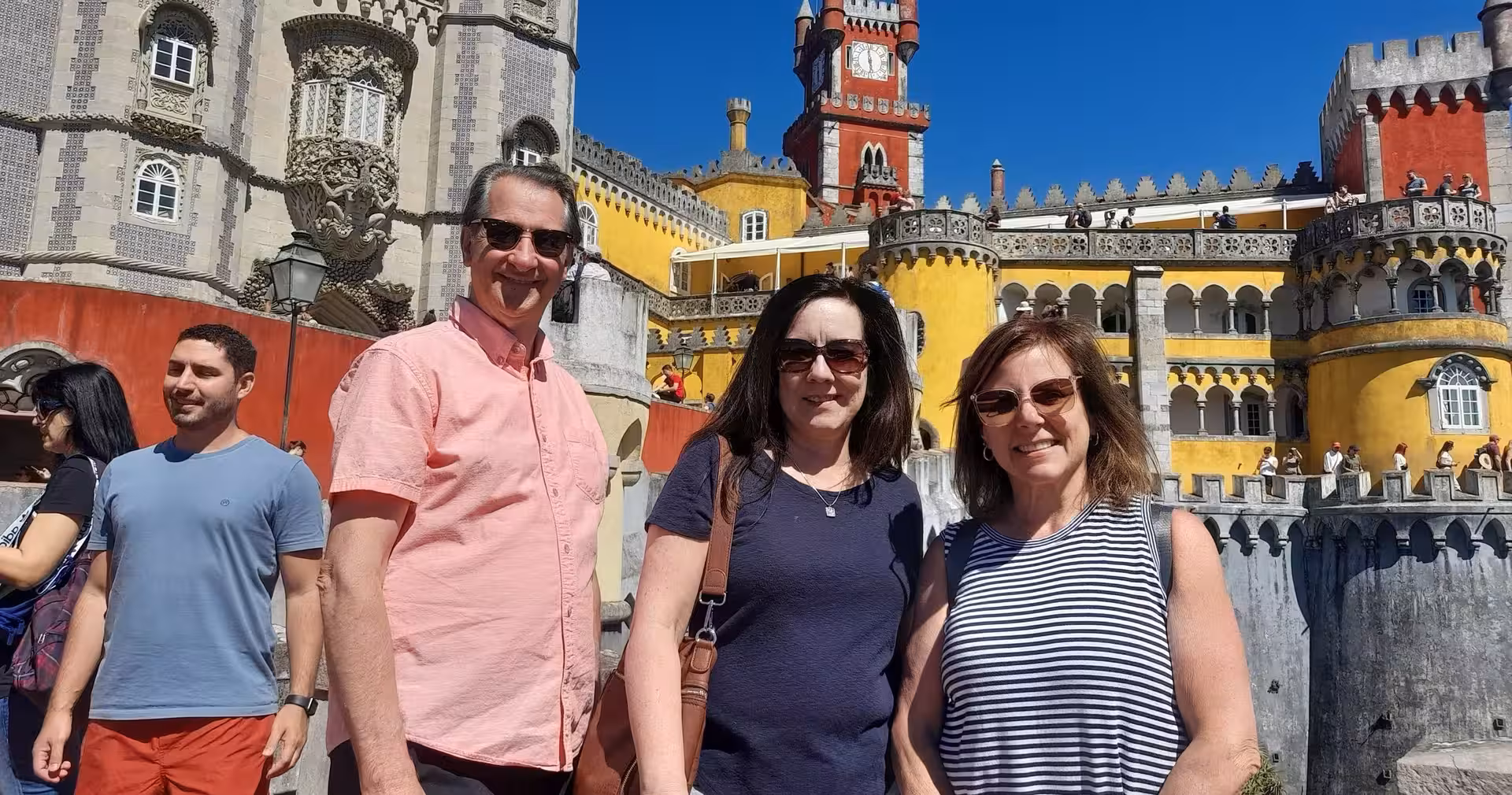 Travelers at Pena Palace in Sintra, a highlight stop on the 7-day Portugal tour from Lisbon to Porto