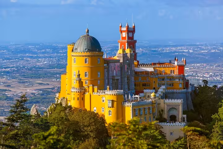 Marvel at Sintra's colorful and majestic Pena Palace overlooking the lush Portuguese landscape on a private tour.