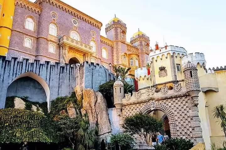 Explore the vibrant architecture of Pena Palace in Sintra on a private tour, featuring Cabo da Roca and Cascais highlights.