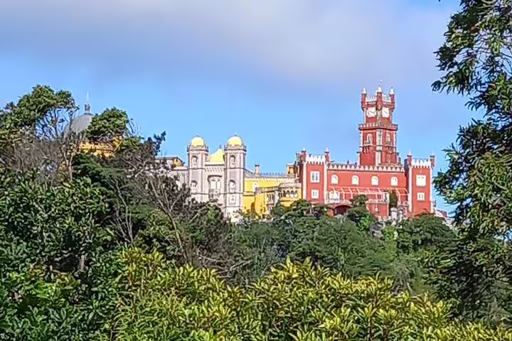 Pena Palace nestled in lush greenery in Sintra, a highlight of the Private Fatima Sintra Tour from Lisbon or Cascais.