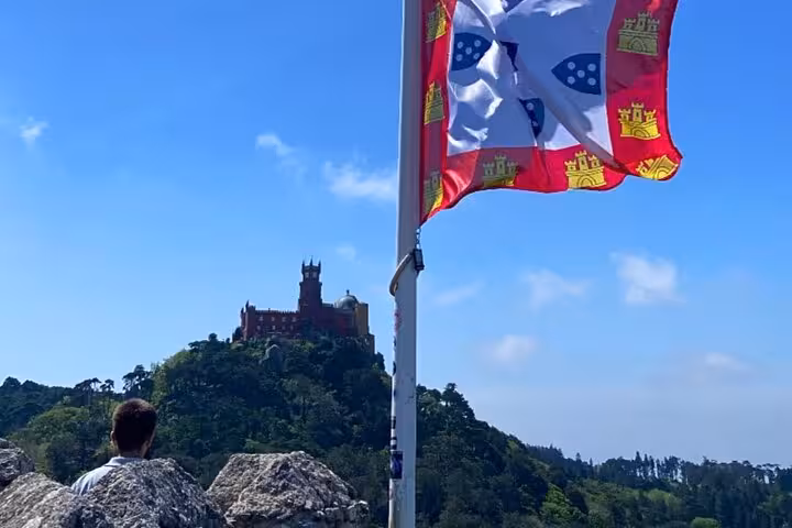 Portuguese flag viewpoint with Pena Palace on Sintra hill, highlight of tuk tuk palaces and coastal tour