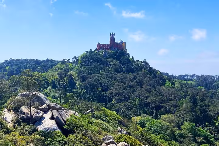 Pena Palace atop Sintra hills on a tuk tuk tour, panoramic forest views and iconic Portugal landmarks