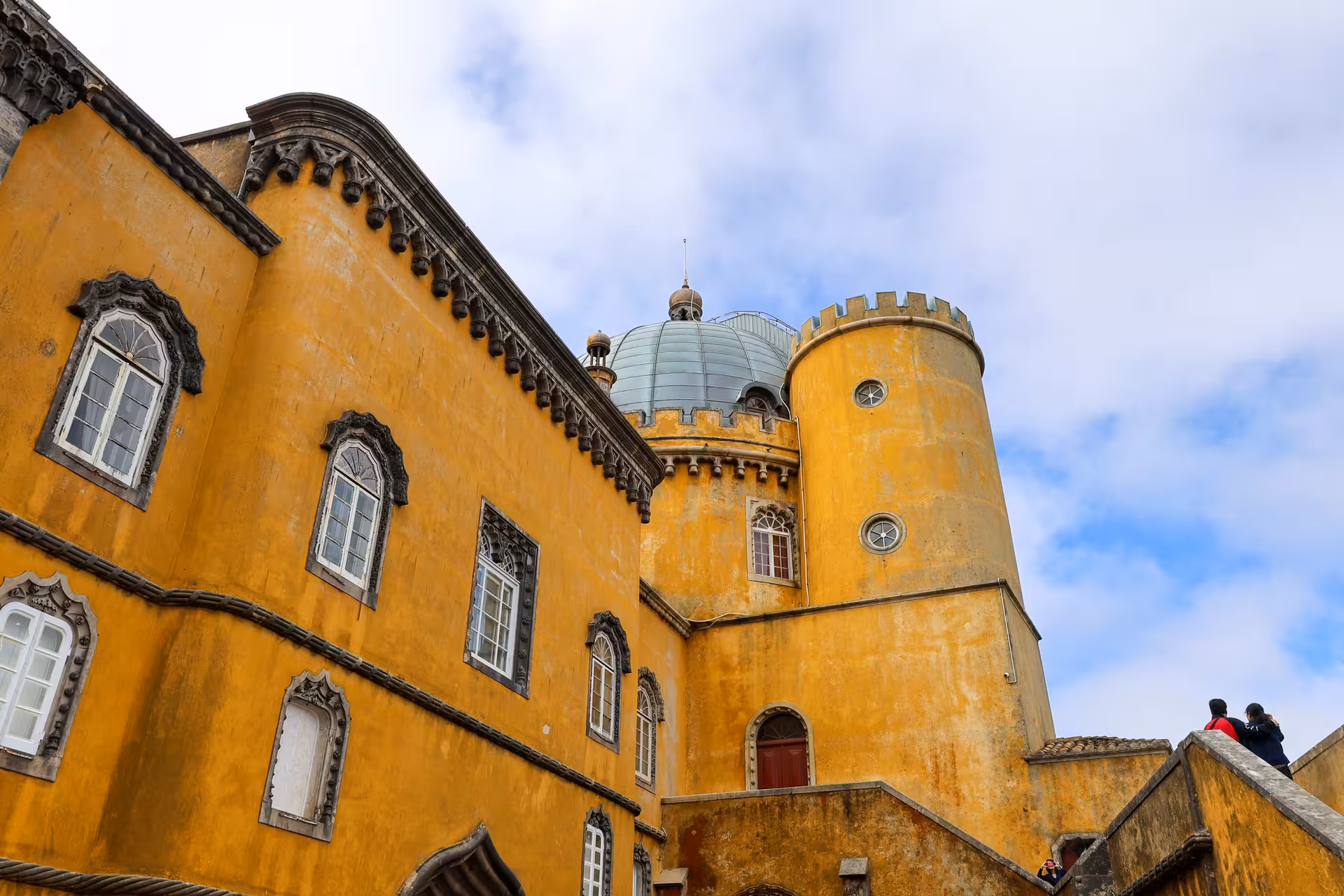 View of the vibrant yellow exterior of Pena Palace, a highlight on the Sintra and wine tasting tour from Lisbon.