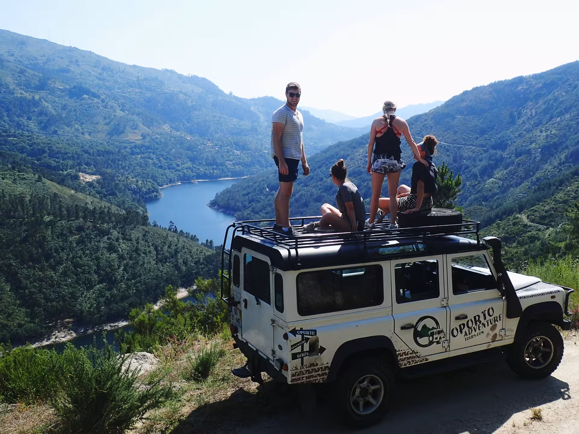 Group enjoying scenic view from a 4x4 vehicle in Peneda-Gerês National Park adventure tour.