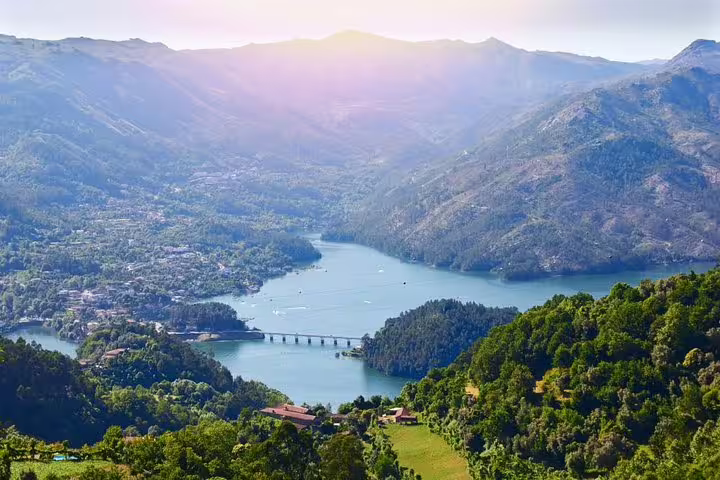 Breathtaking aerial view of Cávado River and mountains in Peneda-Gerês National Park during sunset.