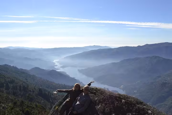 Panoramic mountain view in Peneda-Gerês National Park with two hikers enjoying the breathtaking landscape.