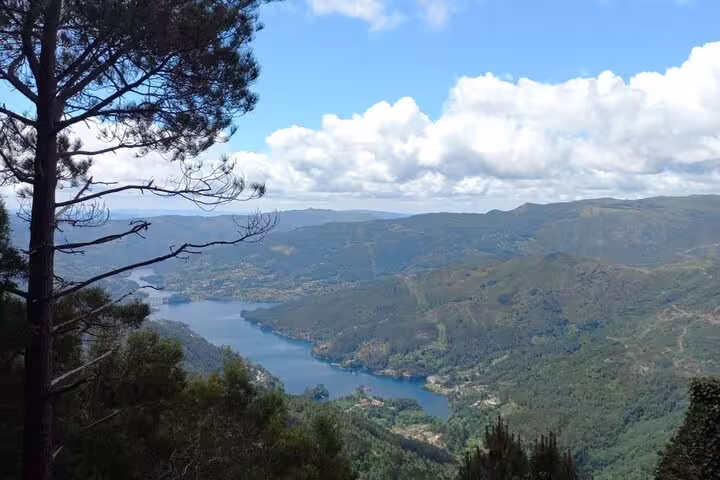 Panoramic vista of Peneda Geres National Park's verdant hills and tranquil lake, ideal for private tours from Porto.