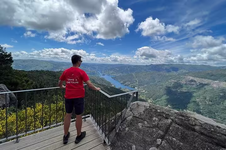 Visitor enjoying a stunning view of Peneda Geres National Park from a scenic lookout on a private tour from Porto.