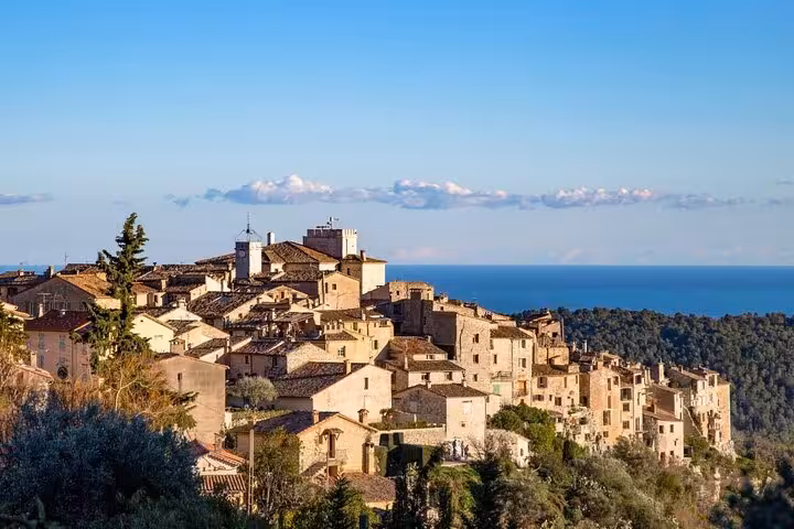 Panoramic view of a picturesque perched village on the French Riviera, overlooking the Mediterranean Sea.