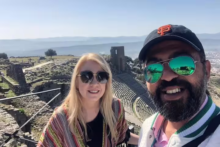 Tourists explore the ancient amphitheater with stunning views on the Pergamon tour from Kusadasi and Selcuk hotels.