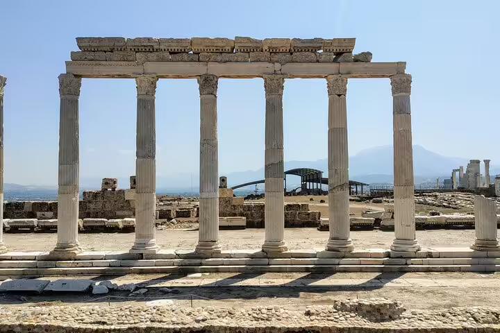 Pergamon archaeological site colonnade on Seven Churches of Asia Minor tour, classical columns under blue sky