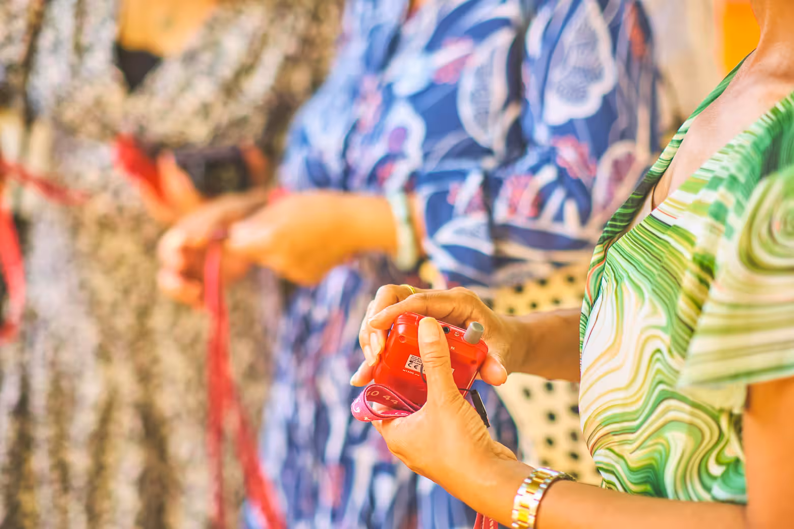 Close-up of hands holding audio guide devices during a cultural tour in the picturesque region of Umbria.