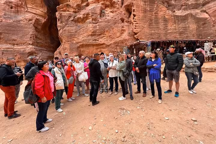 Guided group briefing in Petra canyon market on Sharm El Sheikh to Petra day tour by ferry and bus