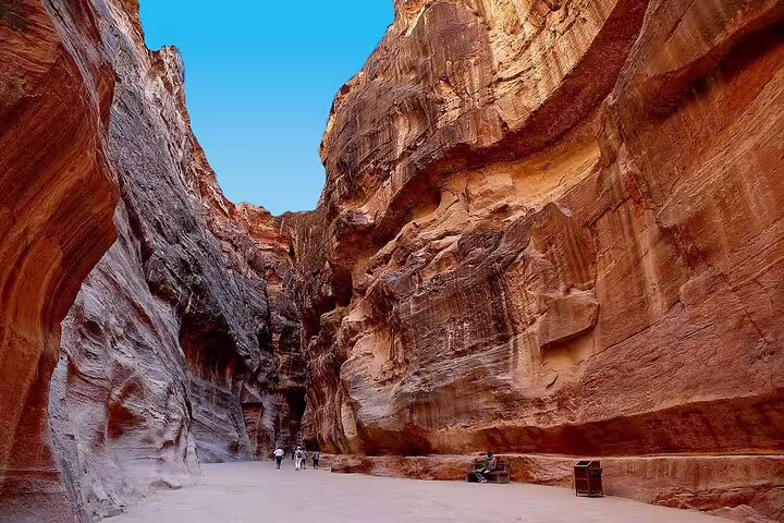 Walking through Petra’s Siq canyon in Jordan on a full-day tour from Sharm El Sheikh with guide