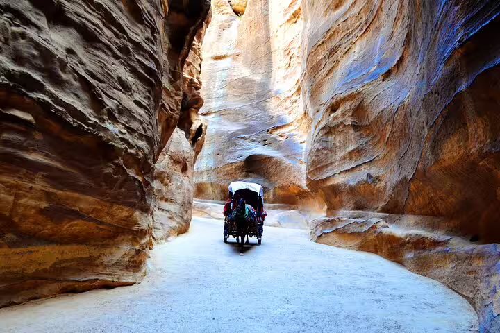 Horse-drawn carriage through Petra Siq canyon on full-day Jordan tour from Sharm El Sheikh