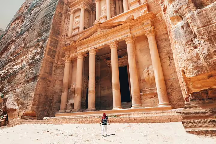 Traveler at Petra Treasury Al-Khazneh entrance, must-see on Petra tour from Taba by ferry boat via ferry