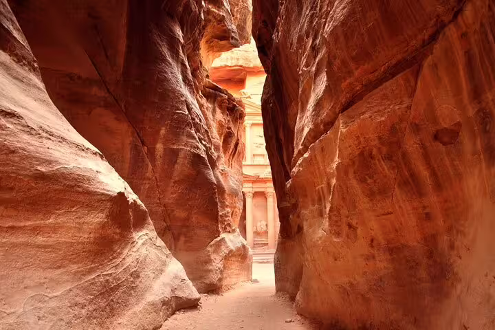 Walking through the Siq canyon to Petra Treasury on a full-day Jordan tour from Sharm El Sheikh