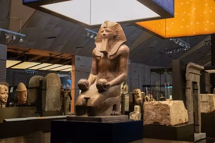 Seated pharaoh statue inside the Grand Egyptian Museum in Cairo, key stop on Sharm El Sheikh excursion