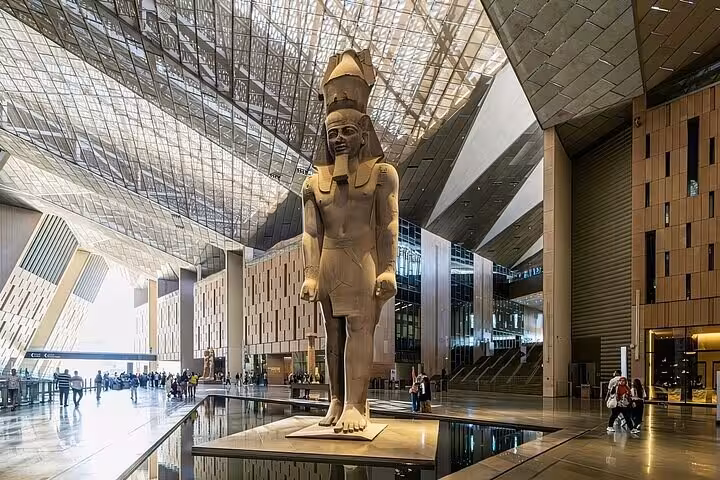 Colossal pharaoh statue in Grand Egyptian Museum atrium, highlight of pyramids and Sphinx tour