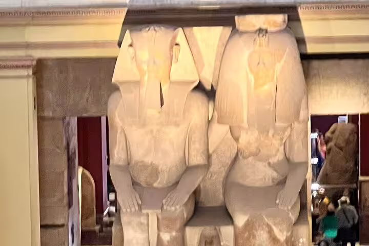 Colossal seated pharaoh statues inside Cairo Museum on Pyramids of Giza and Cairo day tour by plane from Sharm El Sheikh