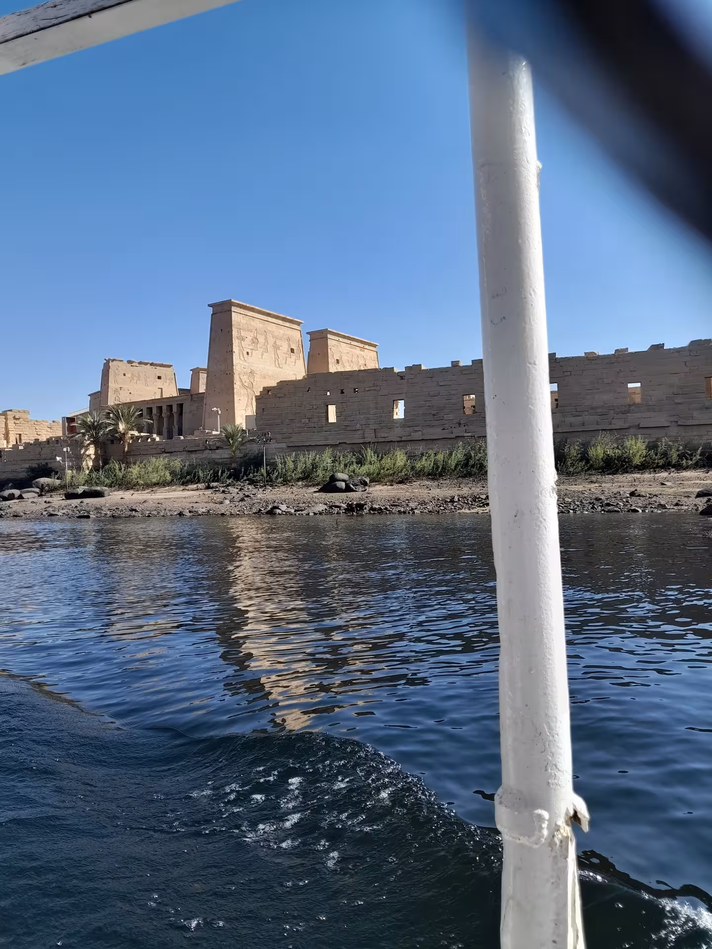 View of Philae Temple from a boat on the Nile River, a highlight of multi-day Luxor and Aswan trips in Egypt.