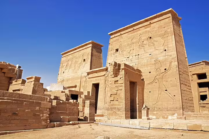 Close-up of Philae Temple pylons with ancient hieroglyphs in Aswan, Egypt, on a private guided tour experience