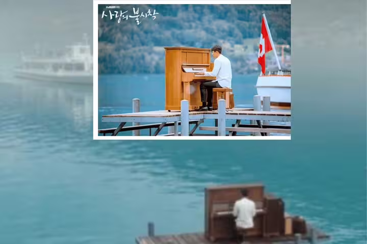 Pianist playing on a wooden dock by Lake Brienz, a highlight location from the Crash Landing on You tour in Switzerland.