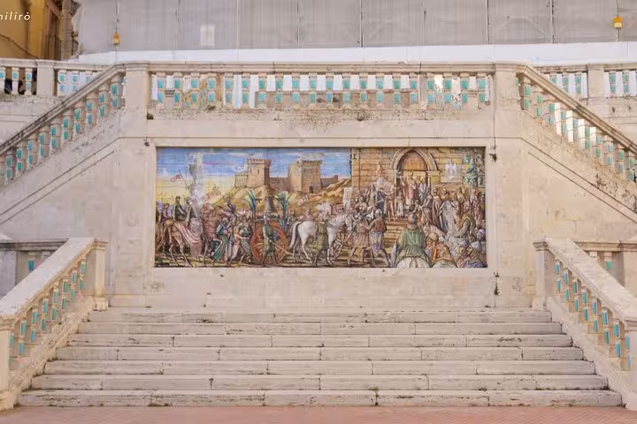 Stunning mosaic mural on the steps of Piazza Armerina, depicting historical scenes with vivid colors and detail.
