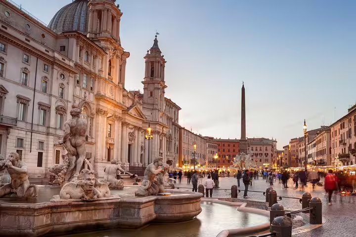 Evening view of Piazza Navona with Baroque fountains, lively crowds and Rome Famous Squares and Fountains group tour route