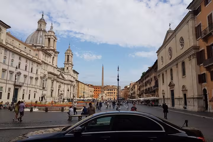 Busy Piazza Navona in Rome with historical architecture and a black car, perfect for Civitavecchia port day trips.