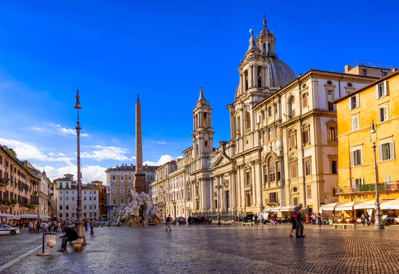 Sunny Piazza Navona in Rome with its iconic fountain and historic architecture, perfect for a culinary exploration.