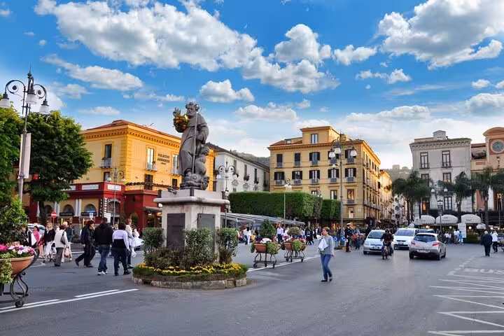 Vibrant Piazza Tasso in Sorrento bustling with tourists, perfect for a guided food and limoncello experience.