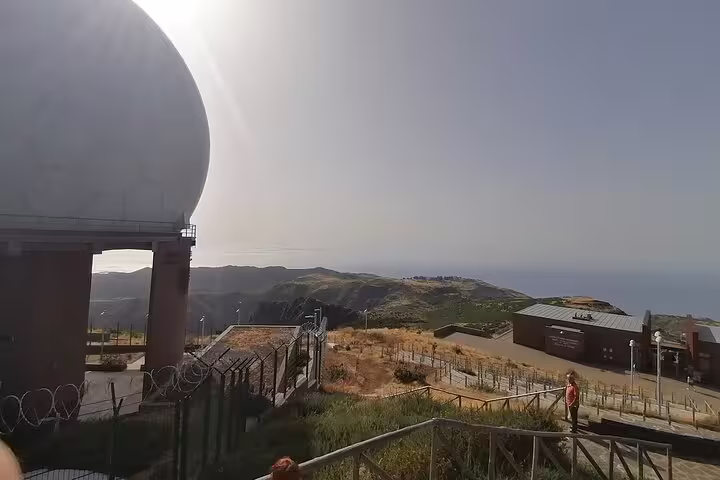 Observatory dome at Pico do Arieiro with stunning views of the Madeira coastline and distant mountains.
