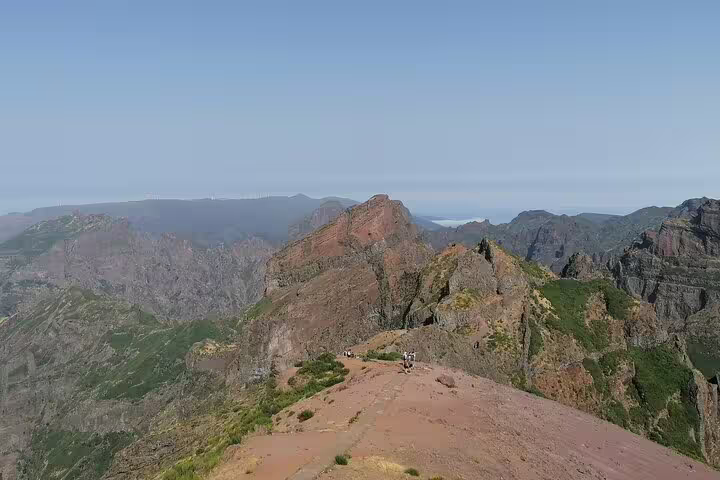 Breathtaking view of Pico do Arieiro's rugged peaks under a clear blue sky, perfect for adventurous hiking tours.