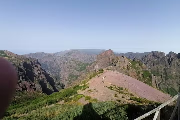Breathtaking view from Pico do Arieiro showcasing rugged mountain peaks under a clear blue sky in Madeira.