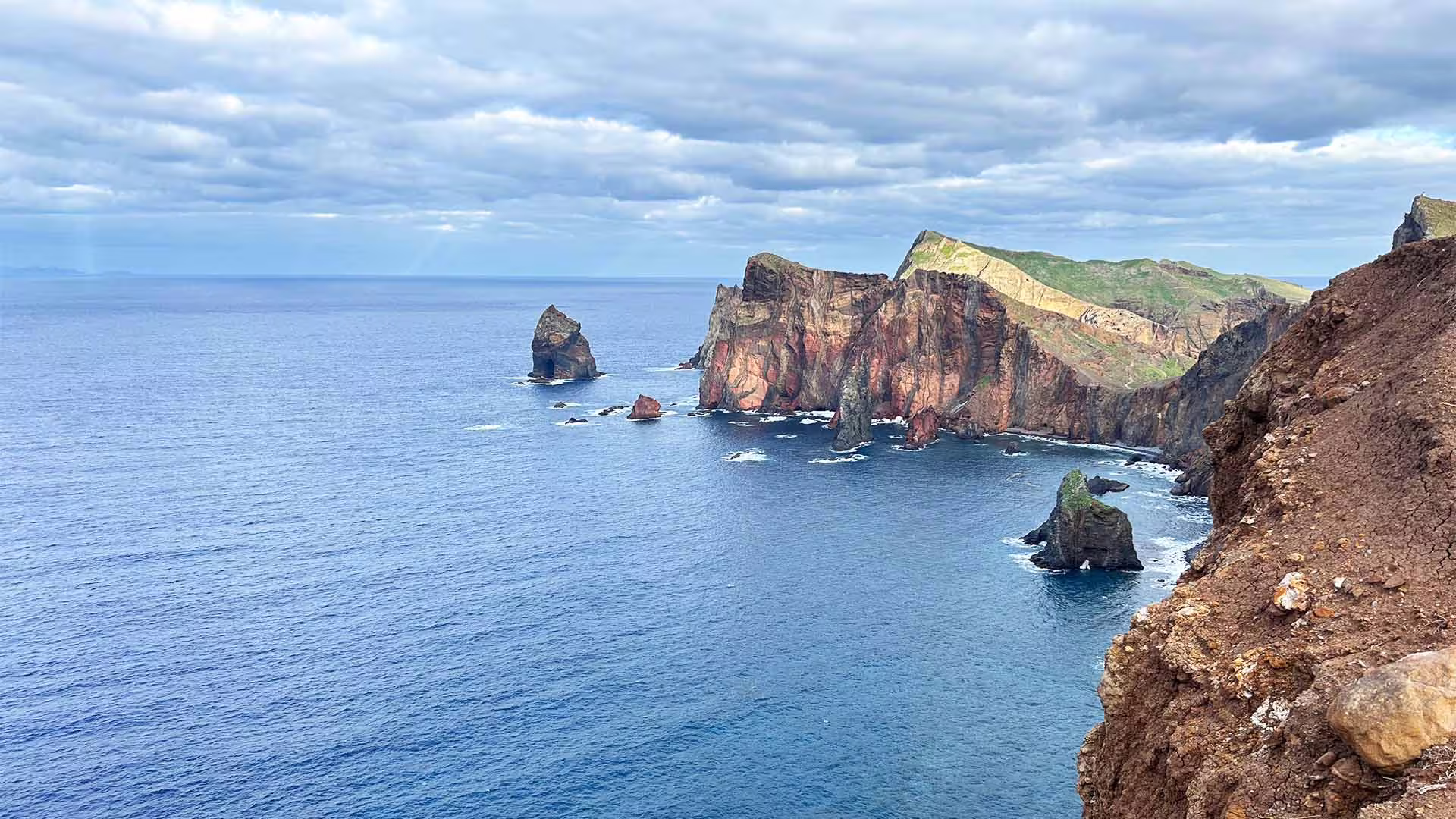 Dramatic coastal cliffs and ocean views on the east side of Madeira, featured in the Pico do Arieiro and Santana full-day tour.