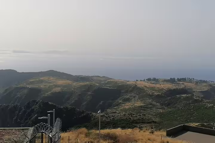 Scenic view from Pico do Arieiro overlooking lush valleys and distant ocean under a clear sky, perfect for hiking tours.