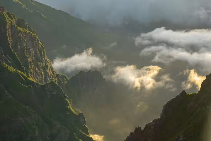 Majestic mountain peaks bathed in morning light and mist on the Pico do Arieiro self-guided sunrise hike.