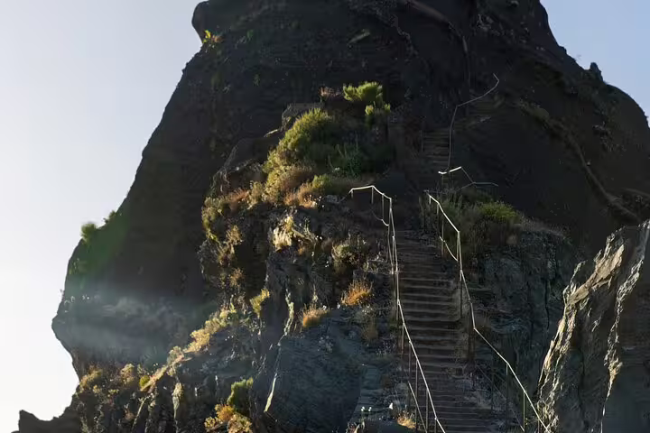 Dramatic stairway ascending rugged cliffs at Pico do Arieiro, inviting explorers on a thrilling sunrise hike.