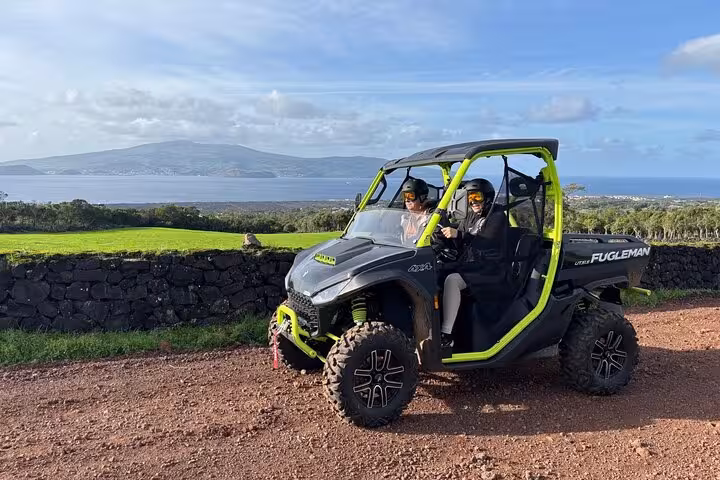 Scenic buggy tour on Pico Island with stunning ocean and mountain views in the background.