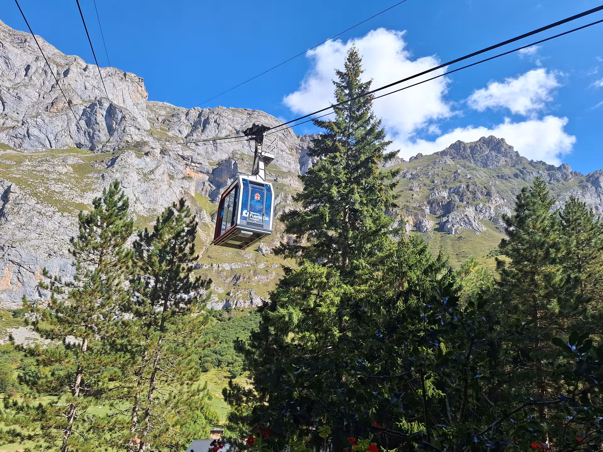 Cable car ascending Picos de Europa mountains offering panoramic views on Santander guided tour.