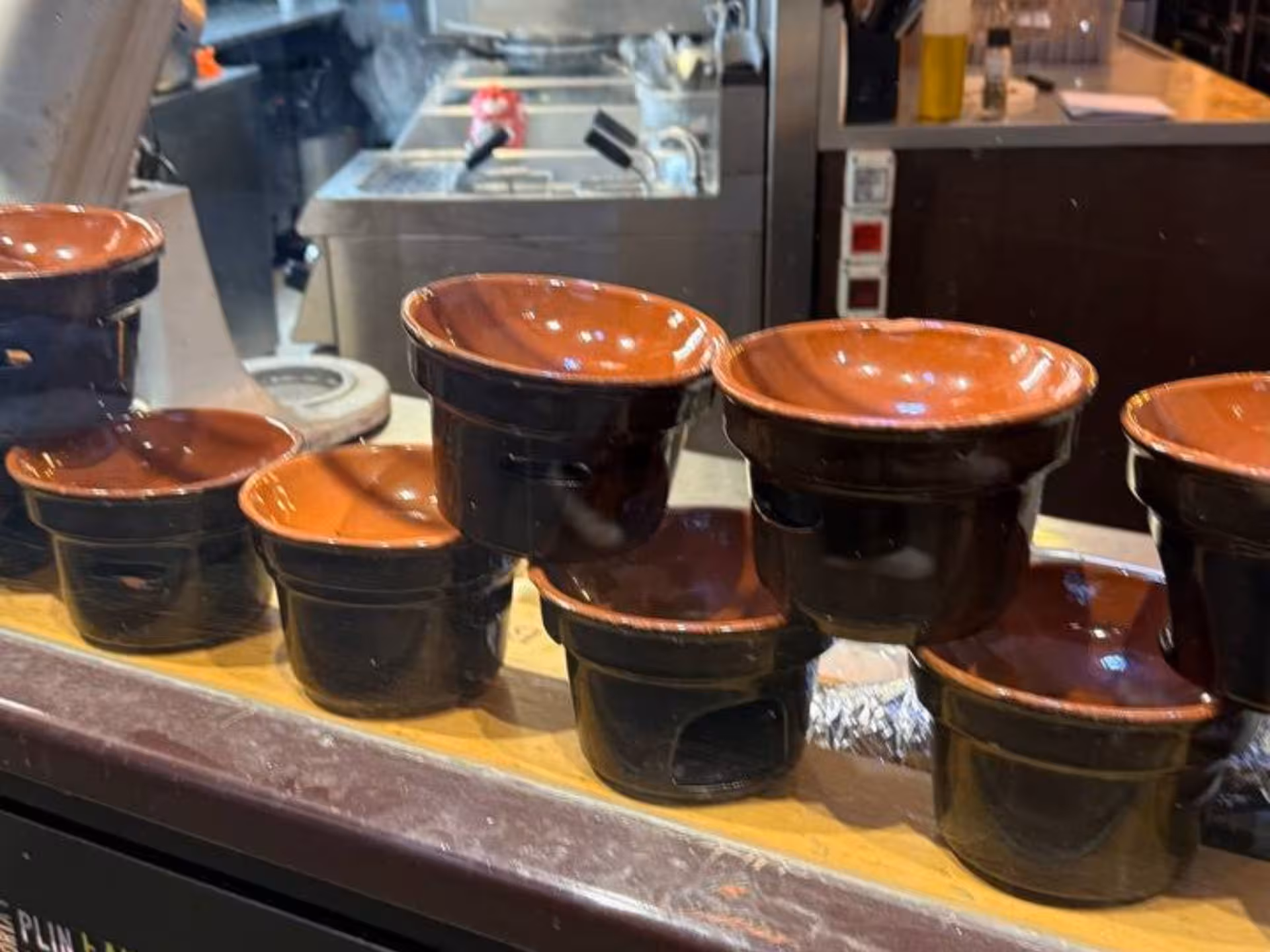 Traditional terracotta bowls on a kitchen counter, ideal for serving Piedmontese tapas in Turin.