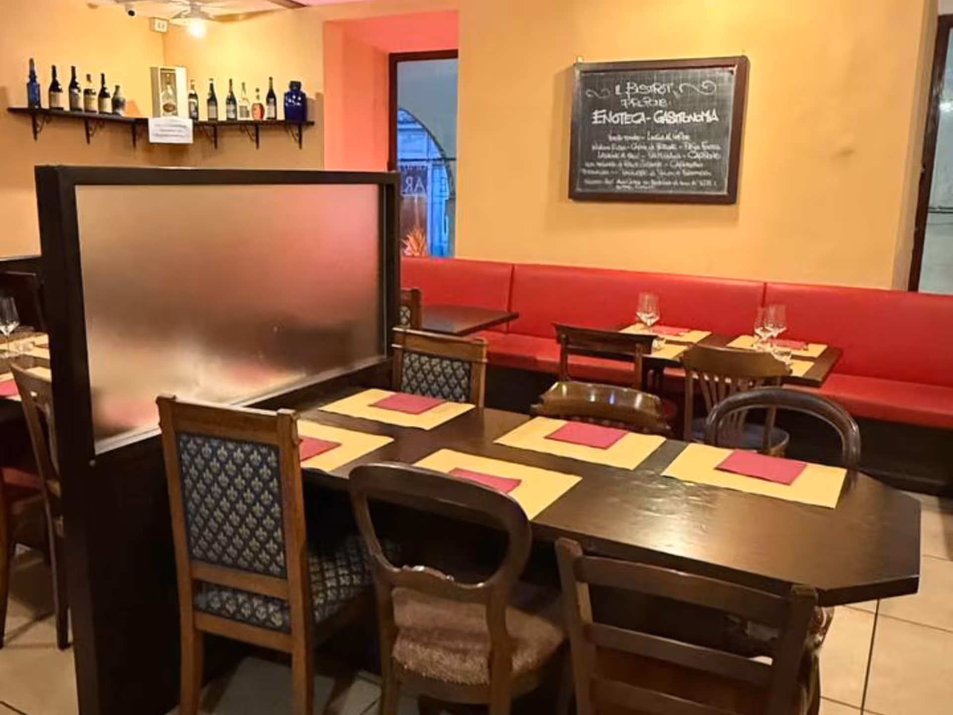 Cozy Turin restaurant interior set for Piedmontese tapas and wine tasting, featuring warm lighting and decor.